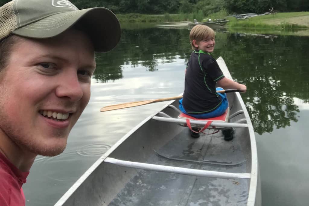 Lucas and Max boating in a small pond.