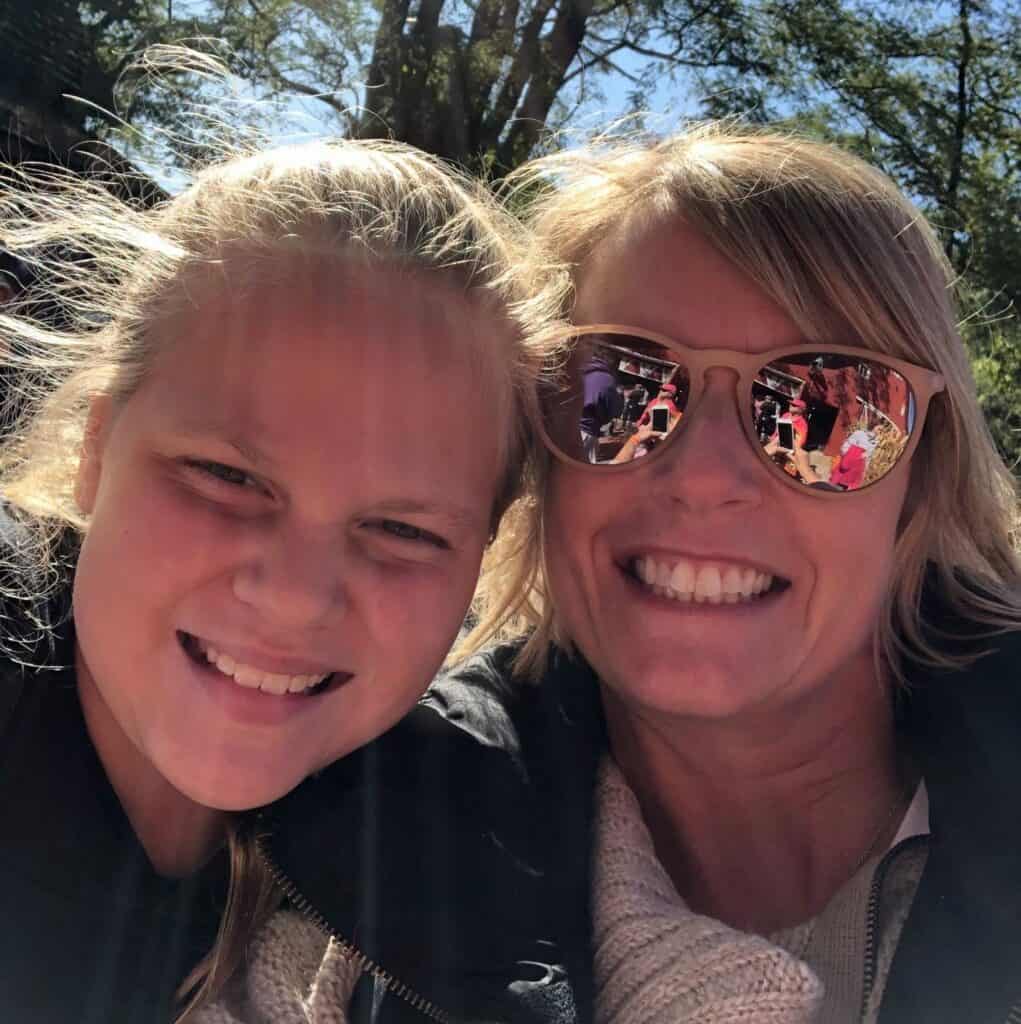 A young woman and her mentor pose for a selfie outdoors