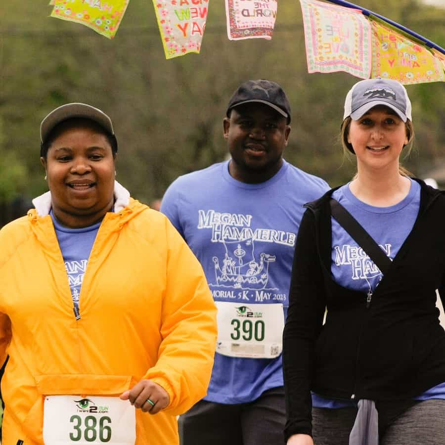 Three walkers at the 2023 Megan Hammerle 5K come across the finish line.