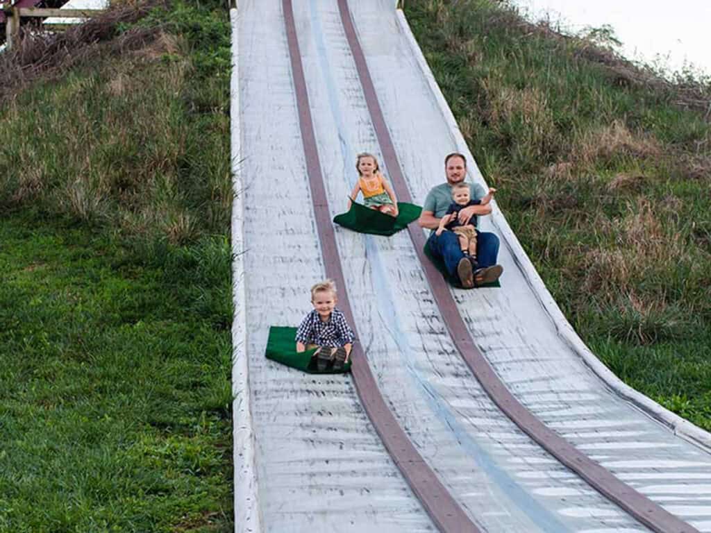 Kids sliding down an outdoor slide