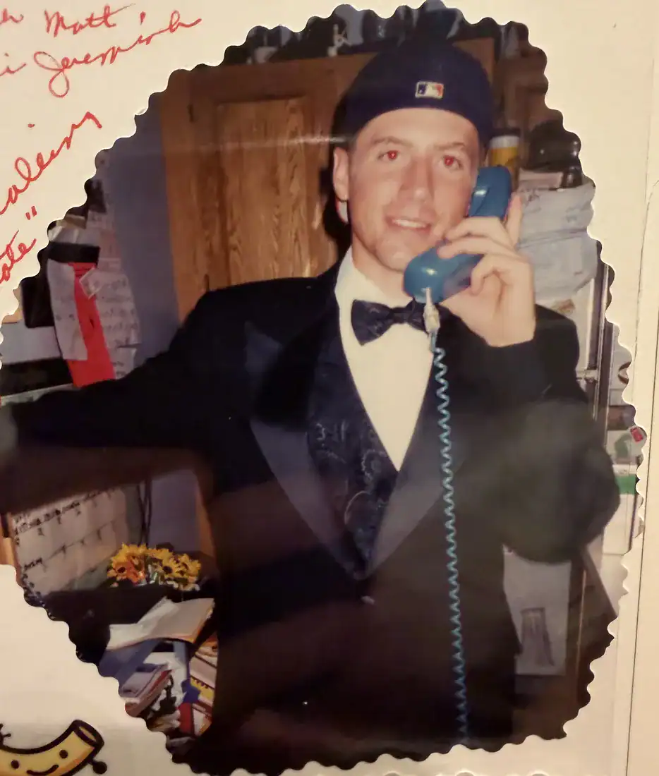 Matt in a tux on a corded phone