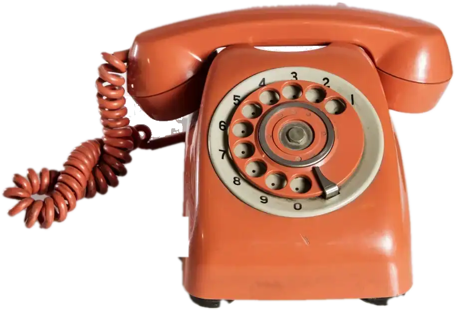 An orange rotary telephone with a coiled cord
